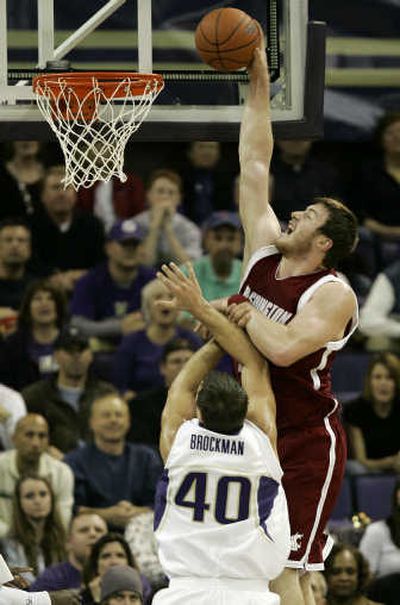 
Washington State center Aron Baynes dunks against Jon Brockman during the first half in Seattle. Associated Press
 (Associated Press / The Spokesman-Review)