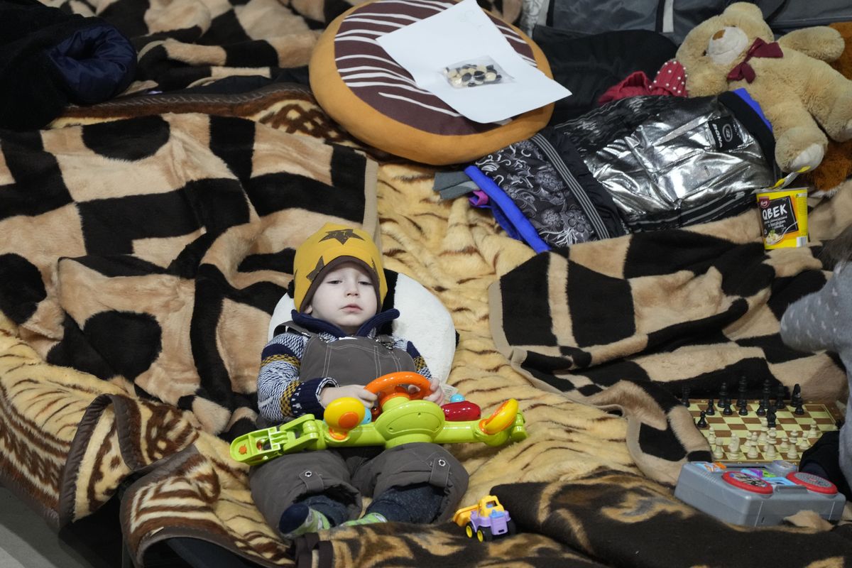 A boy holds a toy Friday as he rests in a center for Ukrainian refugees in Warsaw, Poland.  (Czarek Sokolowski)