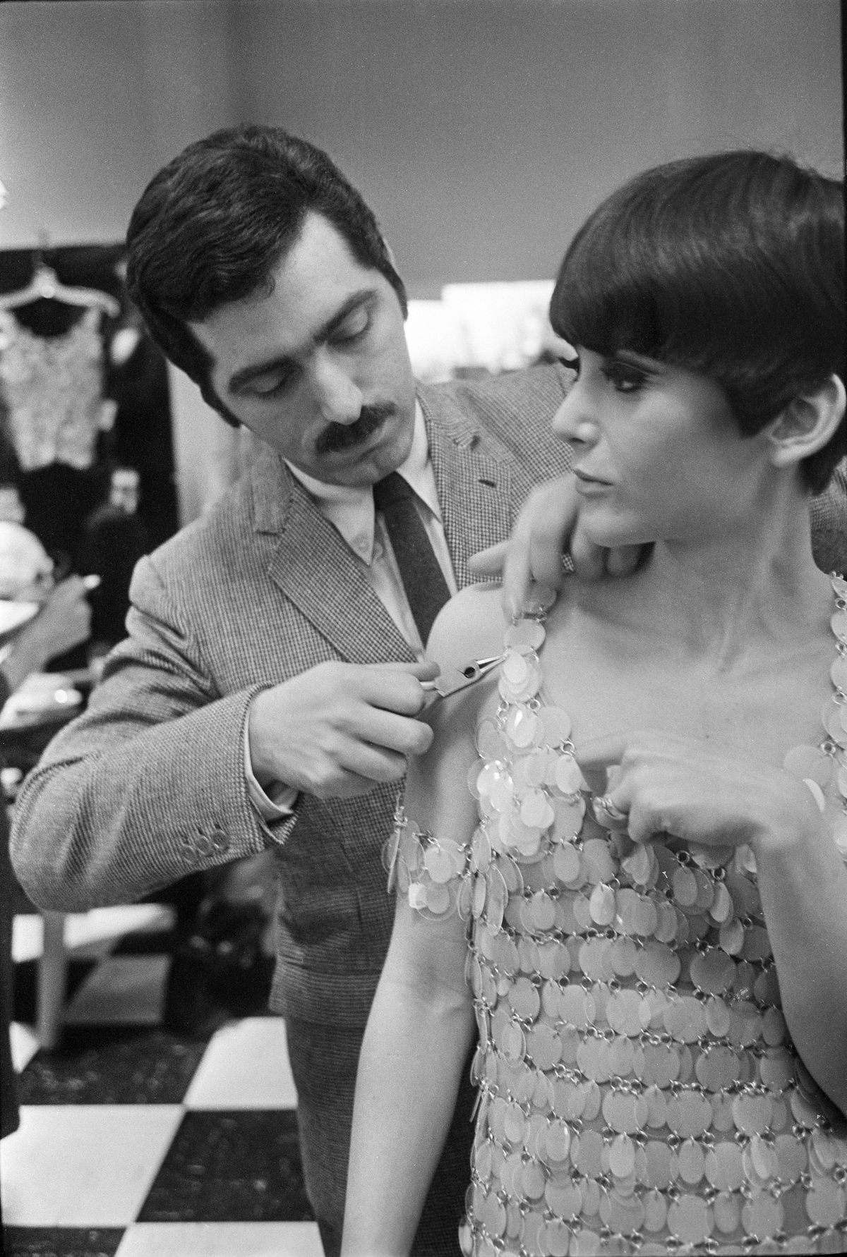 FILE -- The designer Paco Rabanne uses pliers to repair one of his plastic and metal dresses during a show at Lord & Taylor in New York, March 28, 1966. Rabanne, the Spanish designer whose futuristic creations gave shape to the dreams of the space age and redefined couture, died in Portsall, France on Feb. 3, 2023. He was 88. (Neal Boenzi/The New York Times).  (NEAL BOENZI)