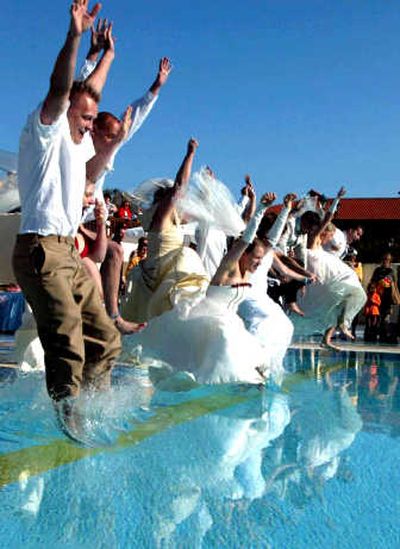 
There are many challenges to owning and maintaining a swimming pool. However, as these newlywed German couples demonstrate, there are also many advantages of having one.
 (AP / The Spokesman-Review)