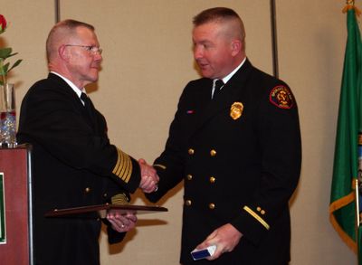 Fire Chief Mike Thompson congratulates Deputy Fire Marshal Rick Freier as he receives the department’s Medal of Valor.  Courtesy of the Spokane Valley Fire Department (Courtesy of the Spokane Valley Fire Department / The Spokesman-Review)