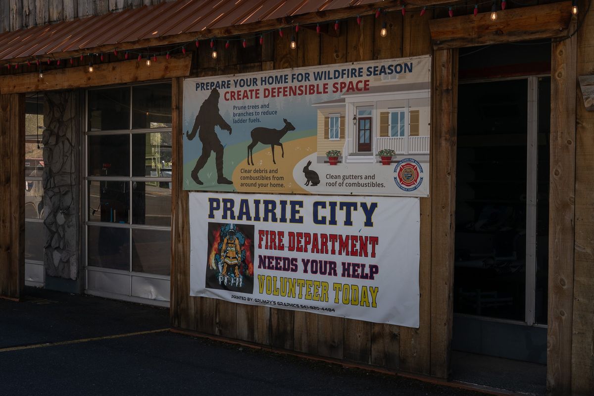 Banners urging preventative action to protect your home from wildfires, and also seeking fire department volunteers, in Prairie City Ore., April 25, 2026. After a warm winter that brought more rain than snow, the Oregon’s snowpack was the lowest it has ever been, which bodes summer water shortages and a high risk of wildfires. (Loren Elliott/The New York Times)  (LOREN ELLIOTT)