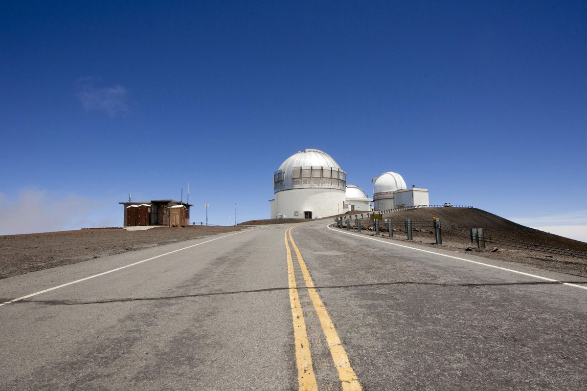 In this Aug. 31, 2015, file photo, telescopes are viewed on Mauna Kea, the proposed construction site for a new $1.4 billion telescope. Scientists are expected to explore fundamental questions about our universe when they use a giant new telescope planned for the summit of Hawaii’s tallest mountain. That includes whether there’s life outside our solar system and how stars and galaxies formed in the earliest years of the universe. But some Native Hawaiians don’t want the Thirty Meter Telescope to be built at Mauna Kea’s summit, saying it will further harm a place they consider sacred. (Caleb Jones / Associated Press)