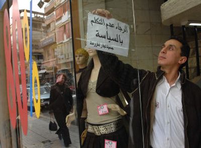 
A Lebanese boutique owner puts up a sign saying 