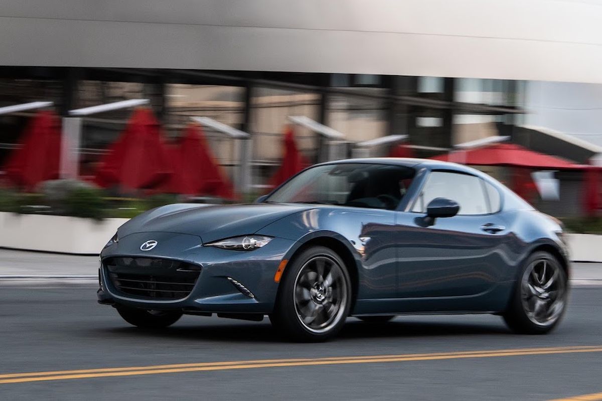 The Miata’s two-passenger cockpit, front-engine/rear-drive architecture and folding canvas roof are borrowed directly from classic European sports cars. (Mazda)