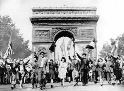 
Parisians march through the Arc de Triomphe waving flags of the Allied nations as they celebrate Victory in Europe Day on May 8, 1945. 
 (File/Associated Press / The Spokesman-Review)
