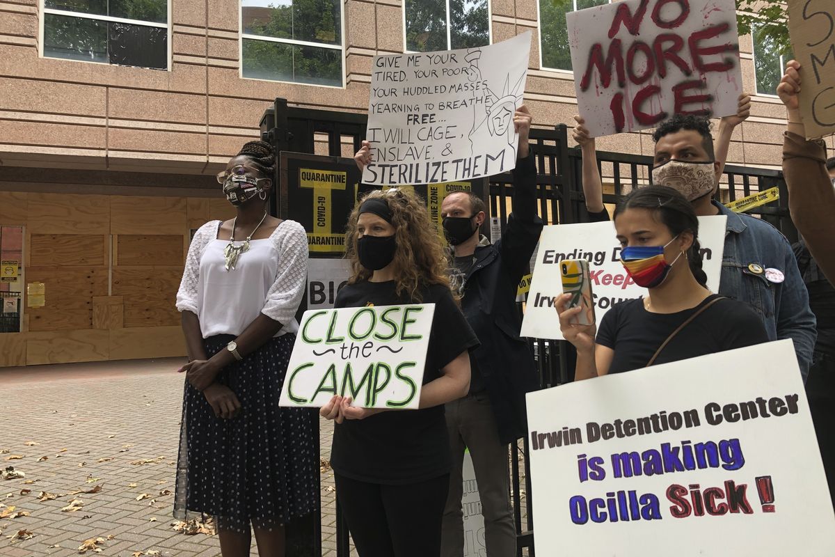 Dawn Wooten, left, a nurse at Irwin County Detention Center in Ocilla, Georgia, speaks at a news conference Tuesday in Atlanta protesting conditions at the immigration jail.  (Associated Press)
