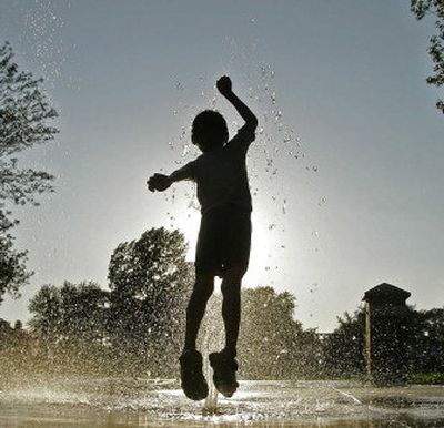 Christopher House, 4, of Green Bay, Wis., cools off in a public water park Monday. The temperature hit 94 degrees.
(Associated Press / The Spokesman-Review)