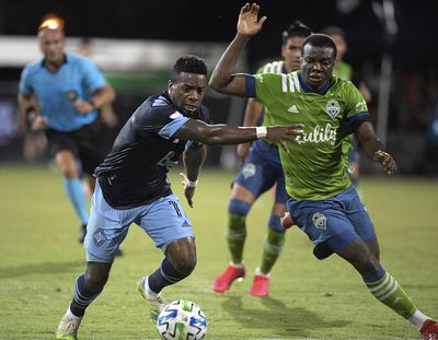 Vancouver Whitecaps forward Cristian Dajome, left, and Seattle Sounders defender Nouhou Tolo compete for a ball during the second half of an MLS soccer match, Sunday, July 19, 2020, in Kissimmee, Fla. (Associated Press)