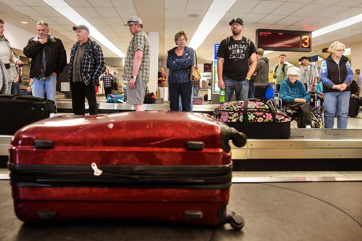 Southwest Airline passengers from Phoenix and their family members wait for belongs at baggage claim in terminal A, April, 3, 2018, at Spokane International Airport. The SIA board approved a $2.8 million design contract for their terminal expansion that will include construction of a centralized baggage claim area, remodel of terminal A/B security checkpoint and greeter hall, remodel of terminal C, and addition of a curbside canopy. (Dan Pelle / The Spokesman-Review)