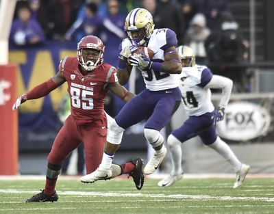 Washington Huskies defensive back Budda Baker (32) intercepts a Luke Falk pass intended for Washington State Cougars wide receiver John Thompson (85) during the second half of the 2016 Apple Cup on Friday, Nov 25, 2016, at Martin Stadium in Pullman, Wash. Washington won the game 45-17. (Tyler Tjomsland / The Spokesman-Review)