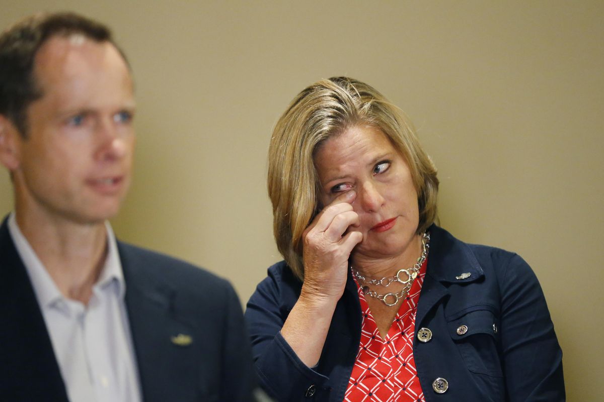 Jill McCluskey wipes her eye as her husband Matthew McCluskey speaks during a news conference, Thursday, June 27, 2019, in Salt Lake City. The family of Lauren McCluskey, a University of Utah student shot on campus, sued the institution on Thursday June 27, 2019, saying officials have refused to take responsibility for missed chances to prevent her death despite multiple reports to police. Lauren McCluskey’s parents said they hope the suit can help protect other women at risk of dating violence on college campuses (Rick Bowmer / Associated Press)