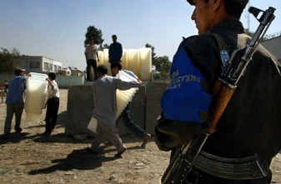 
An Afghan soldier stands guard as ballot boxes are loaded onto a truck Tuesday at a U.N. compound in Kabul to be distributed around the Afghan capital. 
 (Associated Press / The Spokesman-Review)