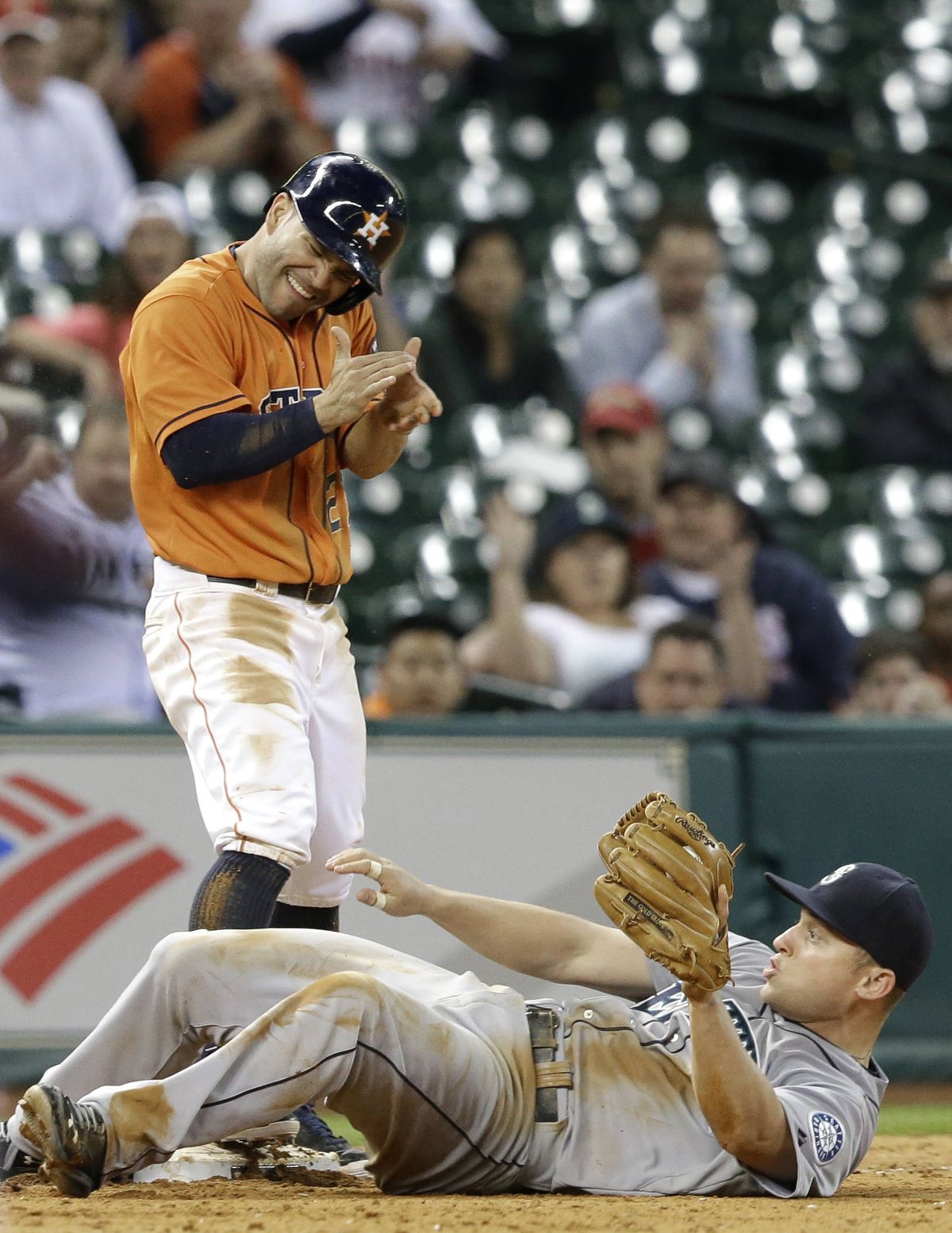 Astros’ Jose Altuve stands over Kyle Seager after beating throw to third base. (Associated Press)