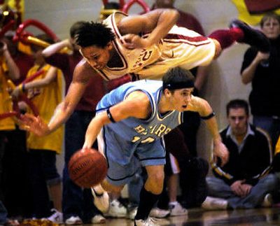 U- Hi's Ian Williamson soars over CV's Blake Trimmer during the 2005 Stinky Sneaker spirit game.
 (File/ / The Spokesman-Review)