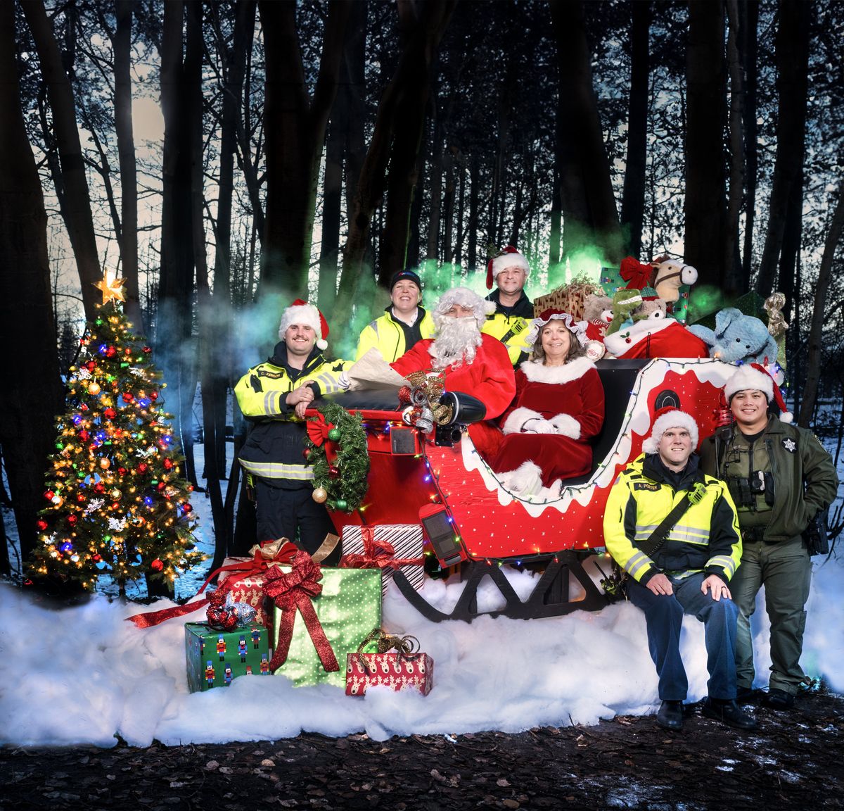 Nestled in a grove of charred birch trees in Medical Lake’s Waterfront Park, first responders to the Gray Fire gather to bring some holiday cheer to wildfire affected community. Left to right top: firefighter Charles Johnson, EMT Erica Norris and firefighter Marcus Lazzar. Middle: Firefighter Hanson Johnson and mayor Terri Cooper. Bottom: Firefighter Aaron Porter and Deputy Lorenz Mina.  (COLIN MULVANY/The Spokesman-Review)