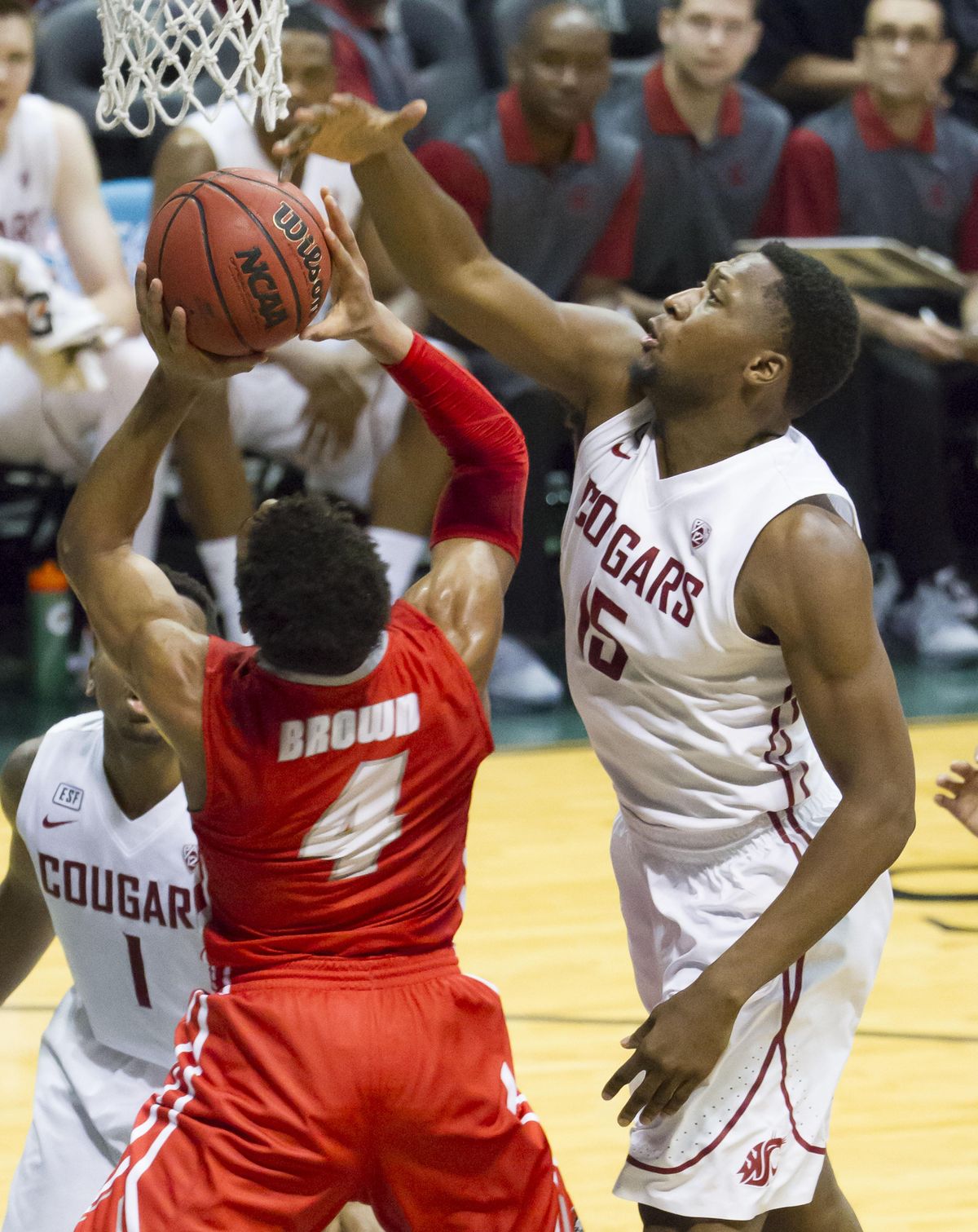 Washington State forward Junior Longrus, right, blocks shot by New Mexico guard Elijah Brown (4) in the first half of game Friday at the Diamond Head Classic, Friday, Dec. 25, 2015, in Honolulu.