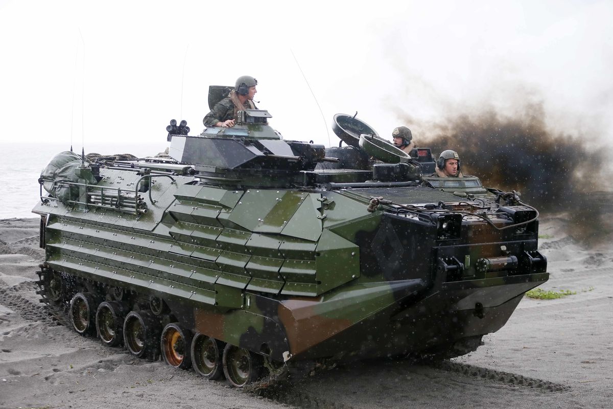 FILE - U.S. Marines from the 3rd Marine Expeditionary Brigade ride on their Amphibious Assault Vehicle (AAV) during the joint US-Philippines amphibious landing exercise Friday Oct.7, 2016 at Naval Education Training Command in San Antonio northwest of Manila, Philippines. A training accident off the coast of Southern California in an AAV similar to this one has taken the life of one Marine, injured two others and left eight missing Thursday, July 30, 2020. In a Friday morning tweet, the Marines say the accident happened Thursday and search and rescue efforts are underway with support from the Navy and Coast Guard.  (Bullit Marquez)