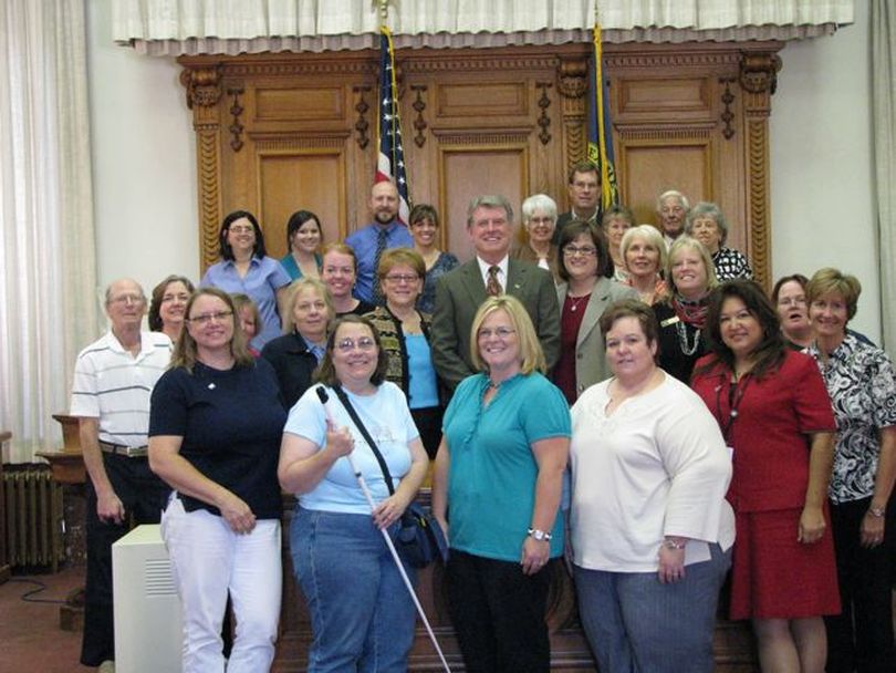 Gov. Butch Otter poses with advocates of community volunteerism after signing a commemorative proclamation for a 