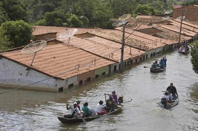 People travel by boat in a flooded street in Trizidela do Vale, Brazil, on Saturday.  (Associated Press / The Spokesman-Review)