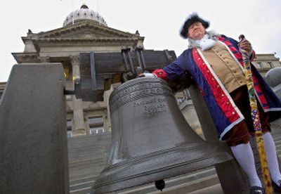 
Benjamin Franklin, as played by Terry Shepard of Boise, stands next to a replica of the Liberty Bell on the steps of the Statehouse on Tuesday after addressing a small crowd. Shepard dressed in the 18th-century outfit on the 300th anniversary of Franklin's birth to ask the Idaho Legislature to pass a resolution proclaiming April 19 of every year Patriot's Day. 
 (Associated Press / The Spokesman-Review)