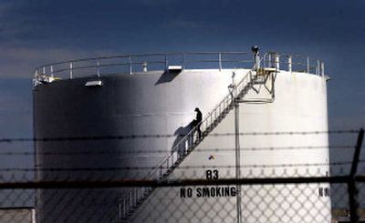 
A worker descends a staircase Monday from atop a fuel tank at the Conoco-Phillips depot in the Spokane Valley. 
 (Brian Plonka / The Spokesman-Review)