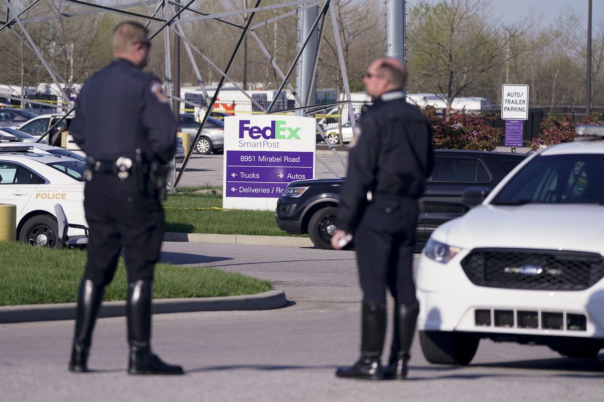 Police stand near the scene where multiple people were shot at the FedEx Ground facility early Friday morning, April 16, 2021, in Indianapolis. A gunman killed eight people and wounded several others before apparently taking his own life in a late-night attack at a FedEx facility near the Indianapolis airport, police said, in the latest in a spate of mass shootings in the United States after a relative lull during the pandemic.  (Michael Conroy/Associated Press)