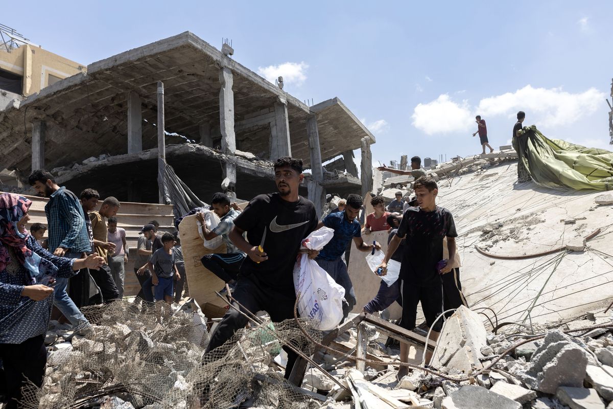 Palestinians rush to collect humanitarian aid that was dropped by parachute from planes flying over Gaza City on Thursday, Aug. 7, 2025. In recent weeks, Israel has come under growing pressure from some longstanding allies to do more to address a hunger crisis in the enclave. (Saher Alghorra/The New York Times)