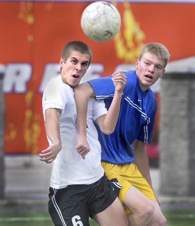 LC’s Ryan Ellingsen, left, and Mead’s Erik Hansen tangle. (Christopher Anderson / The Spokesman-Review)