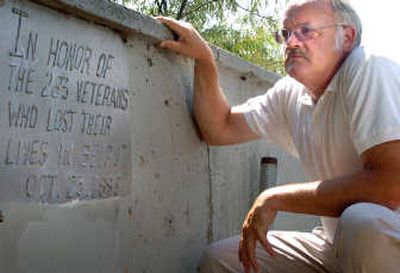 
John Custer poses Friday near the memorial plaque at Veterans' Court in Spokane that he and others erected in honor of service members killed in the 1983 terrorist bombing of Marine Corps barracks in Beirut, Lebanon. 
 (Ingrid Barrentine / The Spokesman-Review)