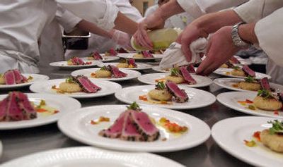 
Students prepare starter plates of fried wasabi risotto, micro greens and coriander encrusted ahi tuna for guests at Washington State University's Feast of the Arts. 
 (Photos by Brian Immel / The Spokesman-Review)