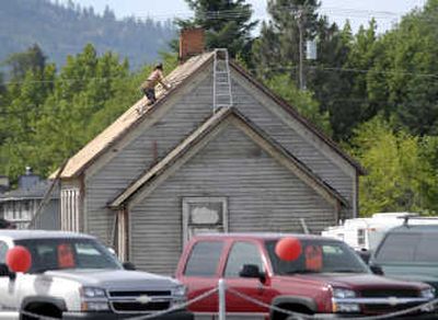 
A roofer works on the Lone Fir Schoolhouse that sits on property owned by Jennifer Johnson. A deal to donate the building to the Spokane Valley Heritage Museum has been called off.
 (J. BART RAYNIAK / The Spokesman-Review)