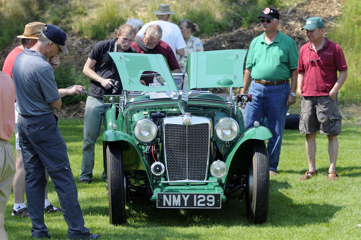 Car owner Jim Buell, second from right, answers questions about his 1949 MG TC at the BritBull XIII car show at Valley Mission Park. (Jesse Tinsley / The Spokesman-Review)