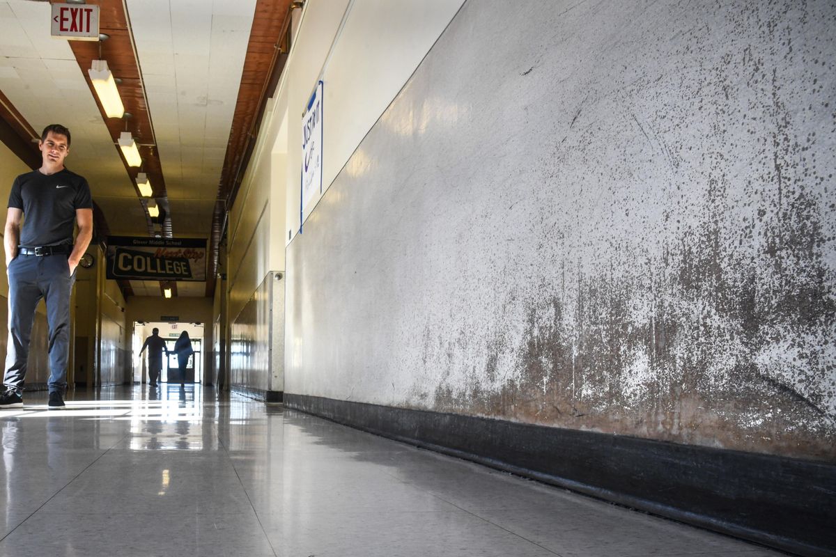 Glover Middle School Principal Mark Lund views the damaged hallway coverings that are not fixable because of asbestos issues. (Dan Pelle / DAN PELLE/The Spokesman-Review)