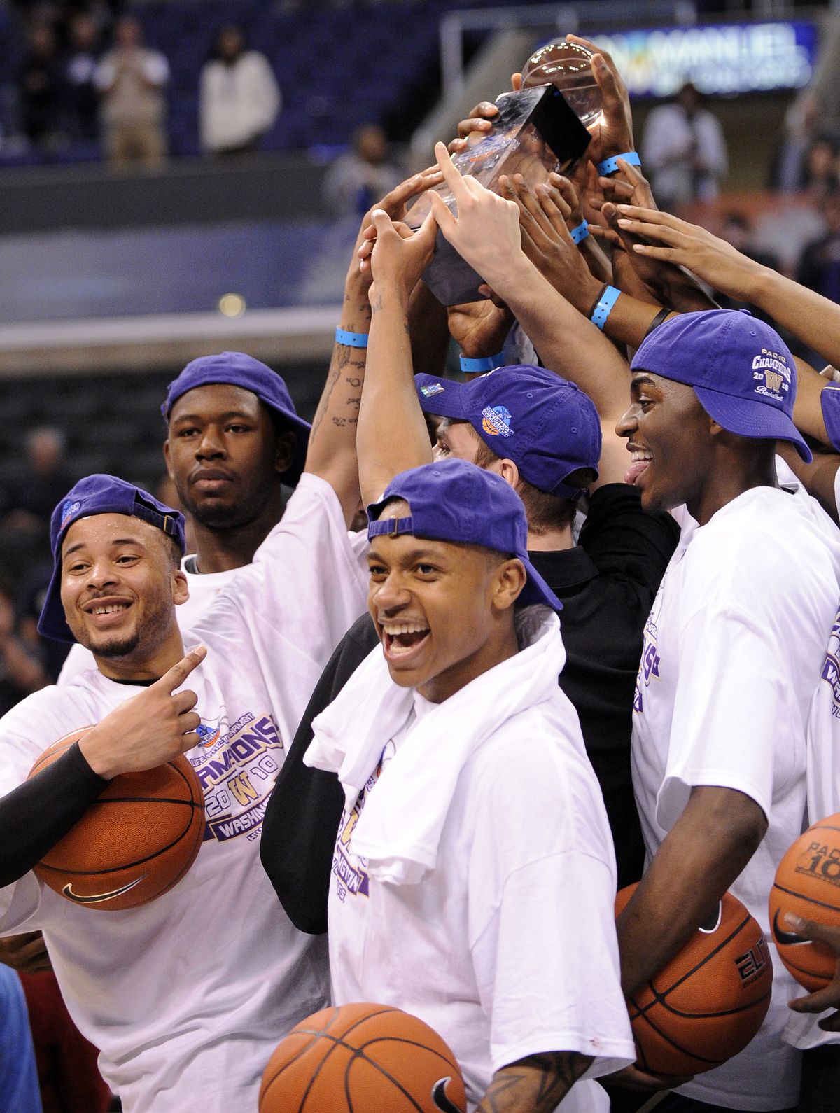 The Huskies hoist the trophy for winning the Pac-10 tournament. (Associated Press)
