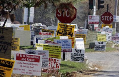 
Scores of signs advertising services related to hurricane damage sprout up on street corners in New Orleans. 
 (Associated Press / The Spokesman-Review)
