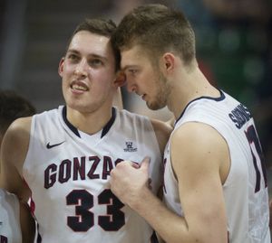 Leaving the court with a hip injury, Gonzaga forward Kyle Wiltjer (33) receives encouragement from teammate Domantas Sabonis (11) in the second half of a WCC men's tournament quarterfinal basketball game, Sat., March 7, 2015, at the Orleans Arena in Las Vegas, Nevada. (Colin Mulvany/SR photo)