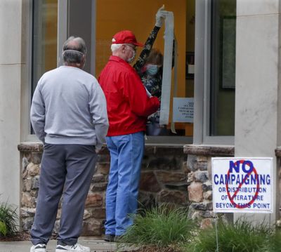 People wait outside as a poll worker prepares the voting place before the polls open for the Pennsylvania Primary election, Tuesday, June 2, 2020, in Zelienople, Pa. (Keith Srakocic / associated press)