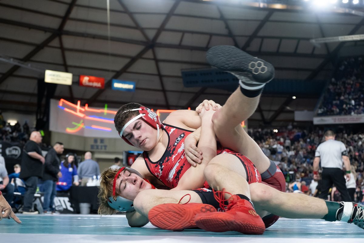 Liberty’s Maddex Strobel, top, pins Okanogan’s Evan Roxby in the quarterfinals of Mat Classic on Friday in Tacoma.  (Madison McCord/The Spokesman-Review)