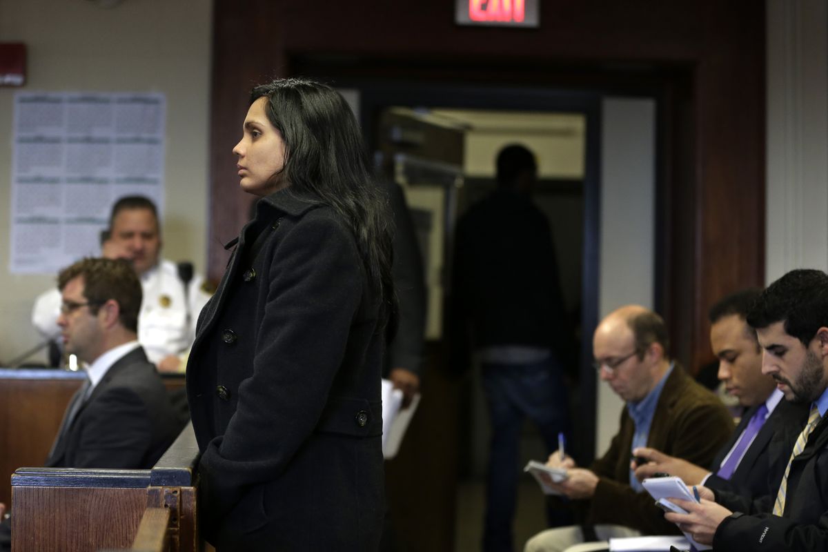 Annie Dookhan, front left, stands during her arraignment at Suffolk Superior Court, in Boston, Thursday, Dec. 20, 2012. Dookhan, the former chemist at the center of a U.S. drug testing scandal, pleaded not guilty to charges including perjury and tampering with evidence. (Steven Senne / Ap, Pool)