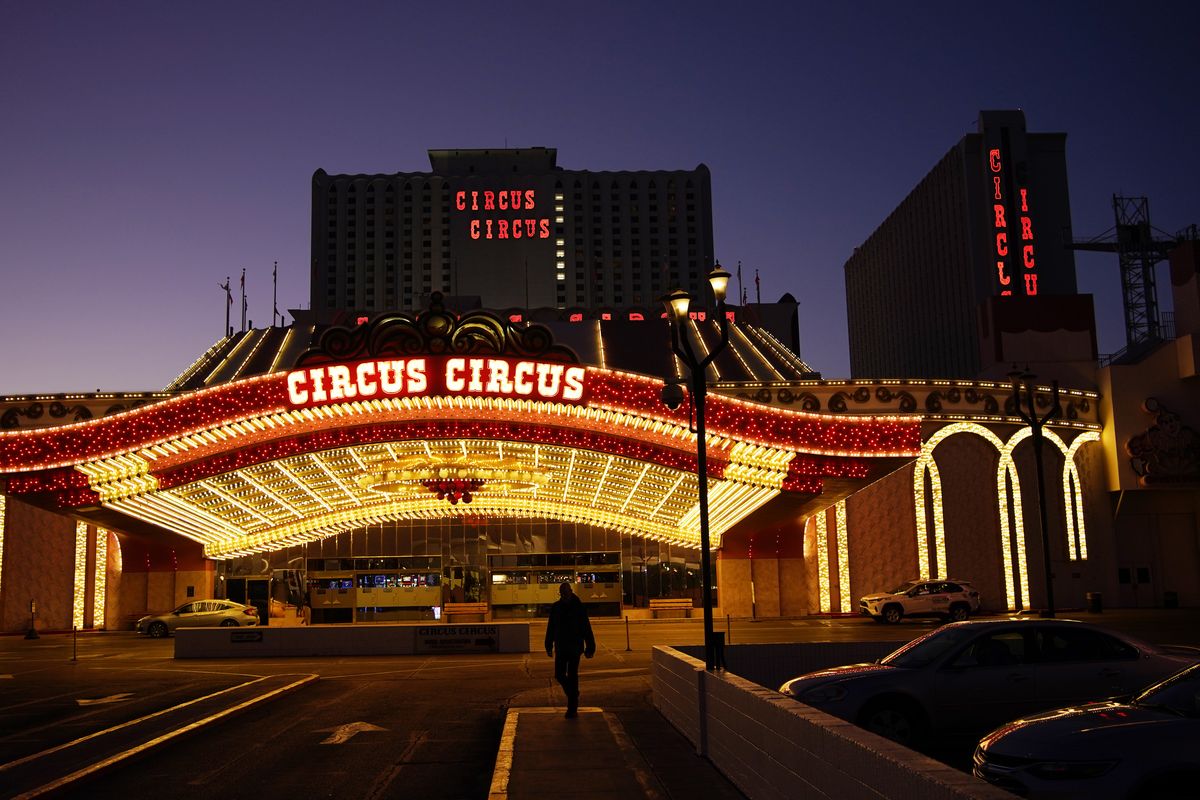 A man walks in front of the Circus Circus hotel and casino in Las Vegas, Feb. 4, 2021. The toll of the coronavirus is reshaping Las Vegas almost a year after the pandemic took hold. The tourist destination known for bright lights, big crowds, indulgent meals and headline shows is a much quieter place these days.  (John Locher)