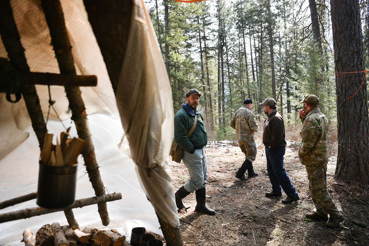 Rick Hall, an Air Force liaison with the Colville National Forest, checks out one of the schools’ training camps on March 9 outside Chewelah, Wash.  (Tyler Tjomsland/The Spokesman-Review)