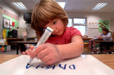 
Dakota Taylor, a kindergartener at Fernan Elementary, writes her name on her whiteboard during class Wednesday. She is one of a growing number of Coeur d'Alene children taking part in extended-day kindergarten. 
 (Jesse Tinsley / The Spokesman-Review)