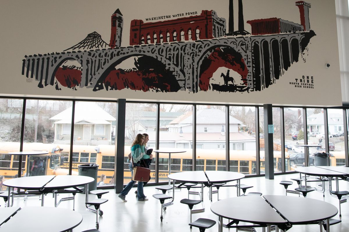 A mural painted by local artist Chris Bovey is seen on Monday, Feb. 4, 2019, at North Central High School in Spokane, Wash. It depicts a view of the Monroe Street Bridge with the Clock Tower, the Pavilion, the Washington Water Power building, the Steam Plant and the Parkade in the background. A Native American man astride a horse is at the bottom, framed in an arch of the bridge. (Tyler Tjomsland / The Spokesman-Review)