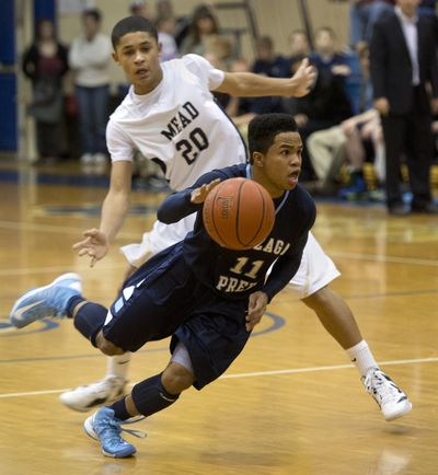 Gonzaga Prep’s Sam Dowd dribbles by Mead’s Max Hess in Thursday’s game – an upset victory for Mead. (Dan Pelle)