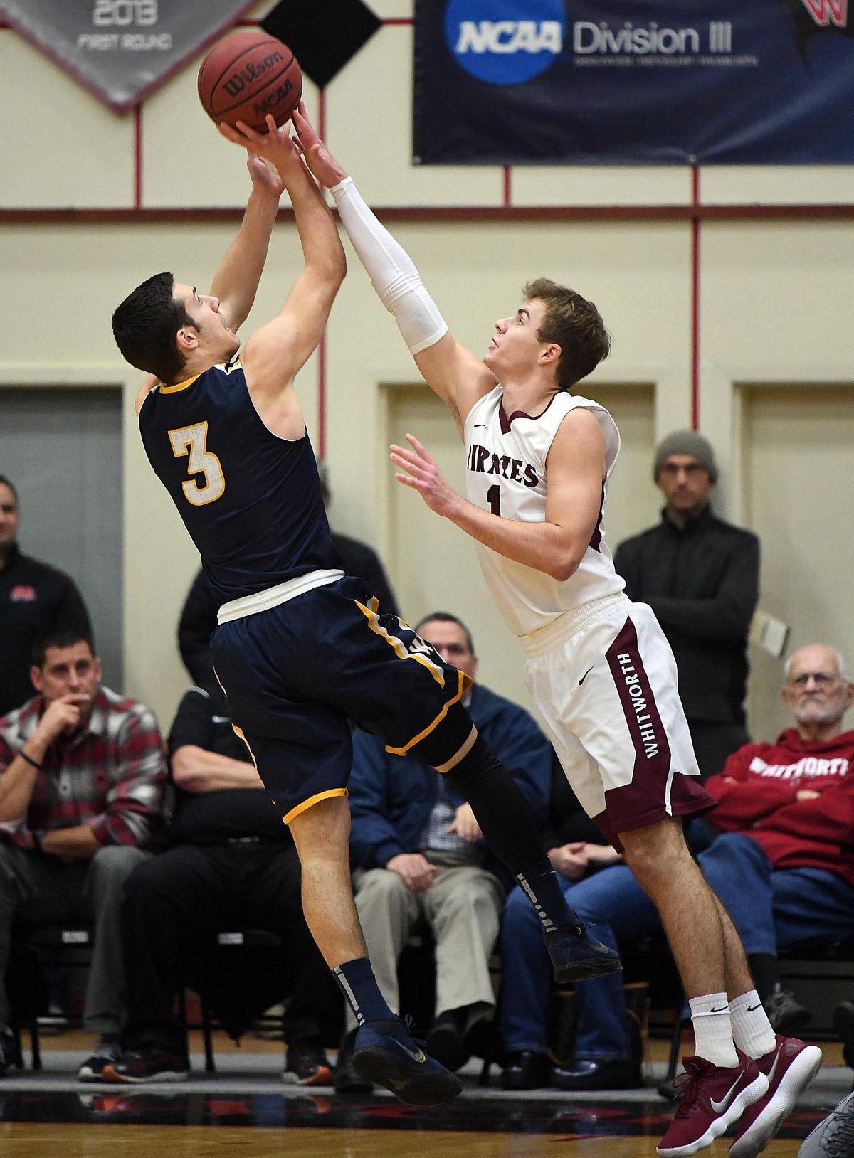 Whitworth guard Kyle Roach (1) tries to stop a shot by Whitman guard Joey Hewitt (3) during the first half of a Division III college basketball game, Tues., Feb. 6, 2018, at Whitworth University. (Colin Mulvany / The Spokesman-Review)