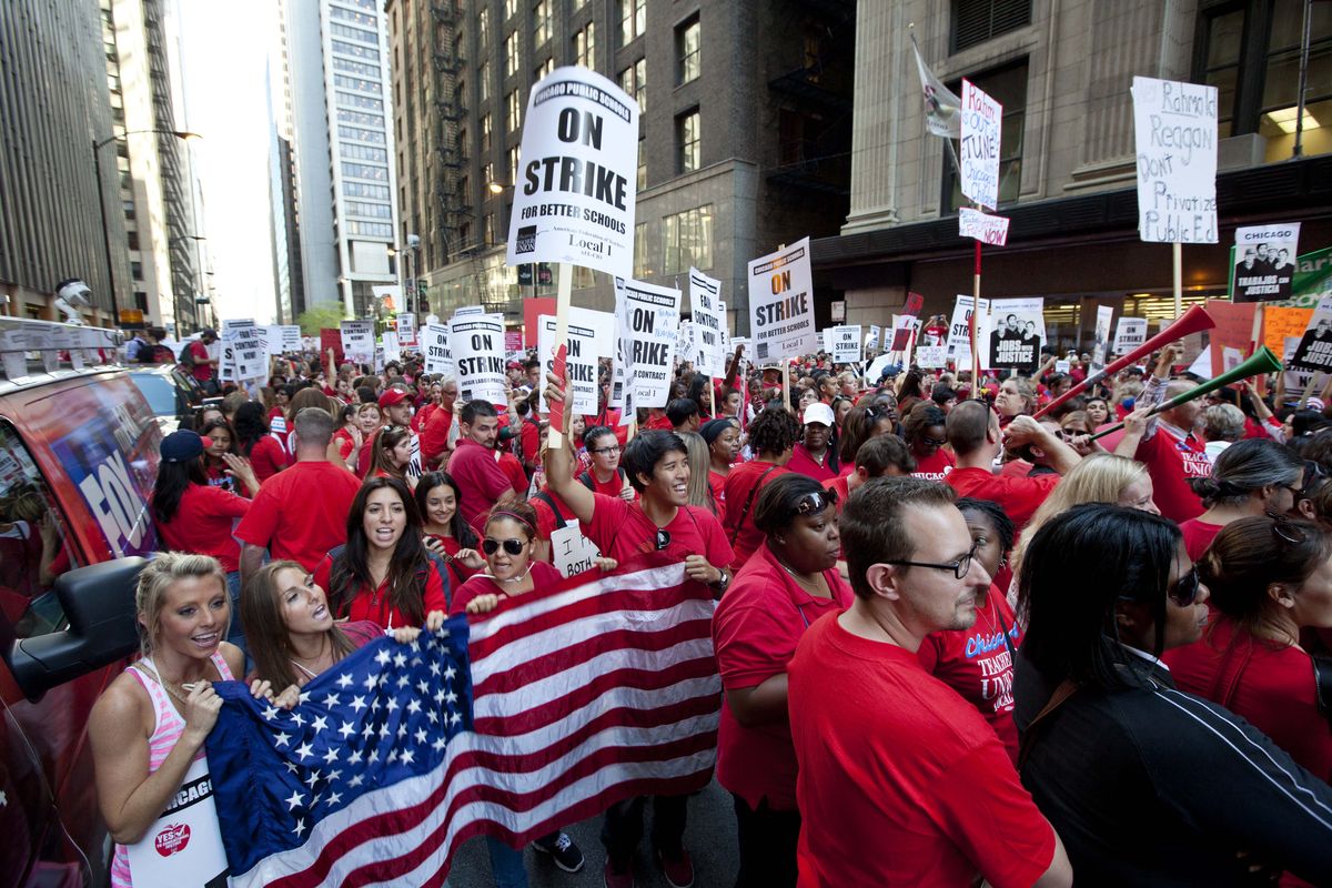 Thousands of public school teachers rally outside the Chicago Public Schools district headquarters on the first day of strike action over teachers