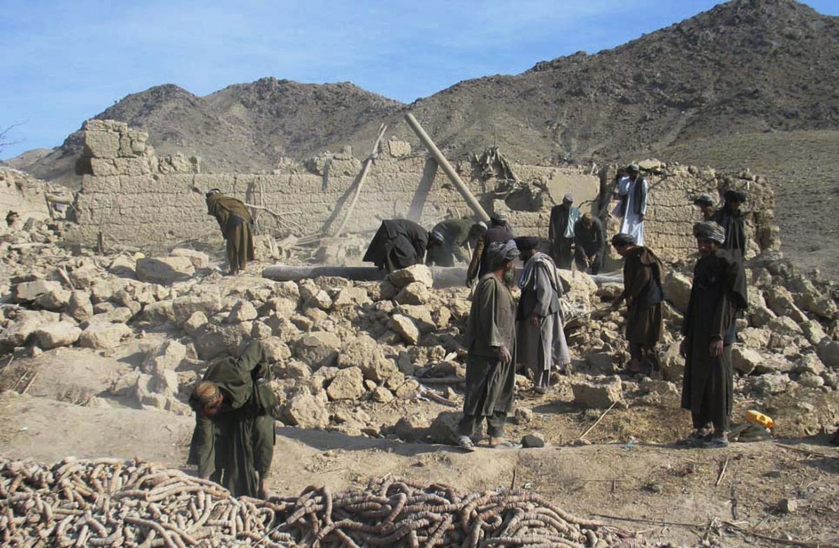 Afghan men work on a house destroyed in an airstrike in Kandahar province on Wednesday.  (Associated Press / The Spokesman-Review)