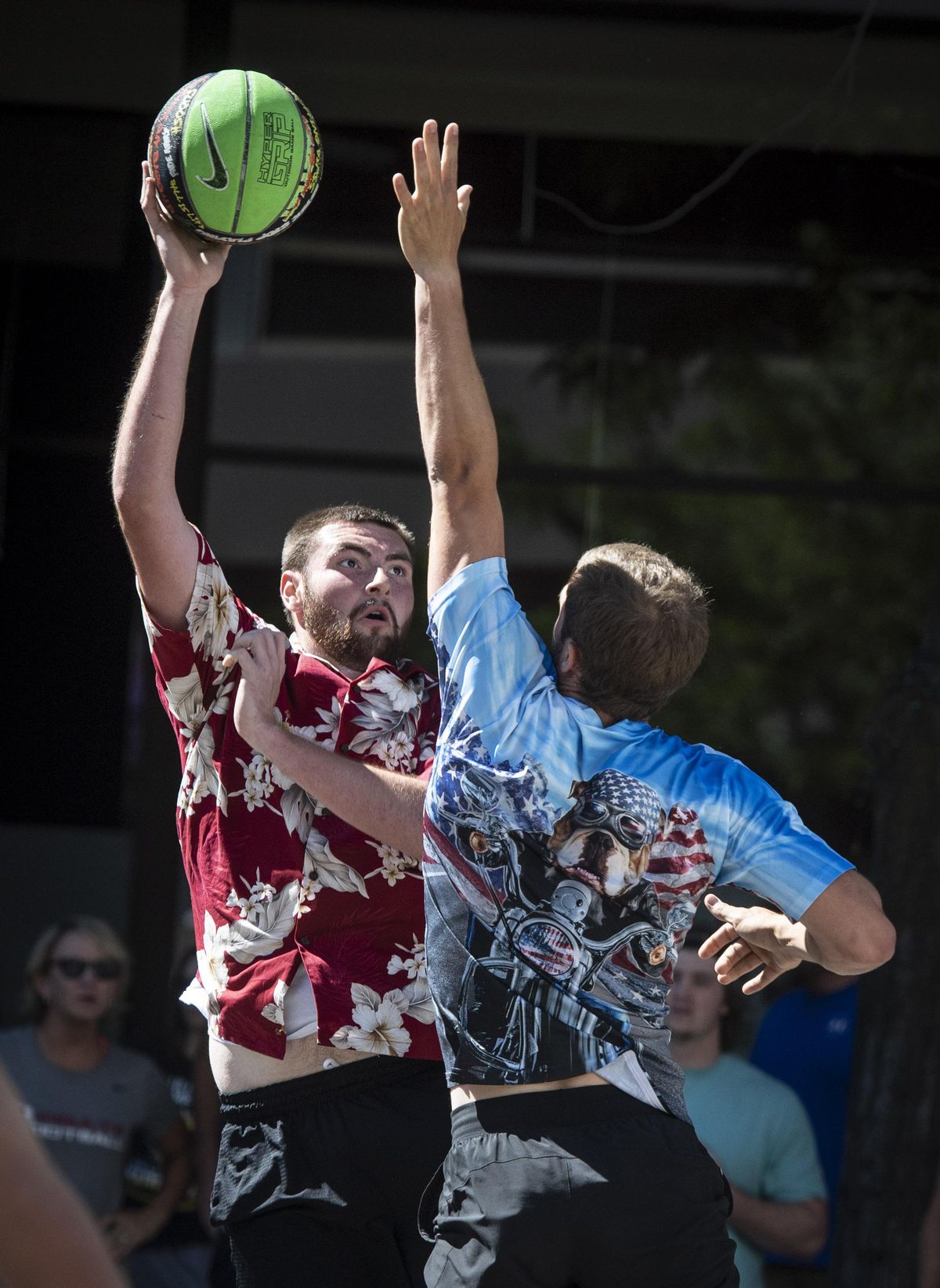 Dressed in a Hawaiian shirt, Redmond Groves with team Hawaiian Punch, takes a shot over a Wild Dawgs opponent Nick McGill during their Hoopfest game on West Riverside Avenue, Sunday July 1, 2018.  Colin Mulvany/THE SPOKESMAN-REVIEW (Colin Mulvany / The Spokesman-Review)