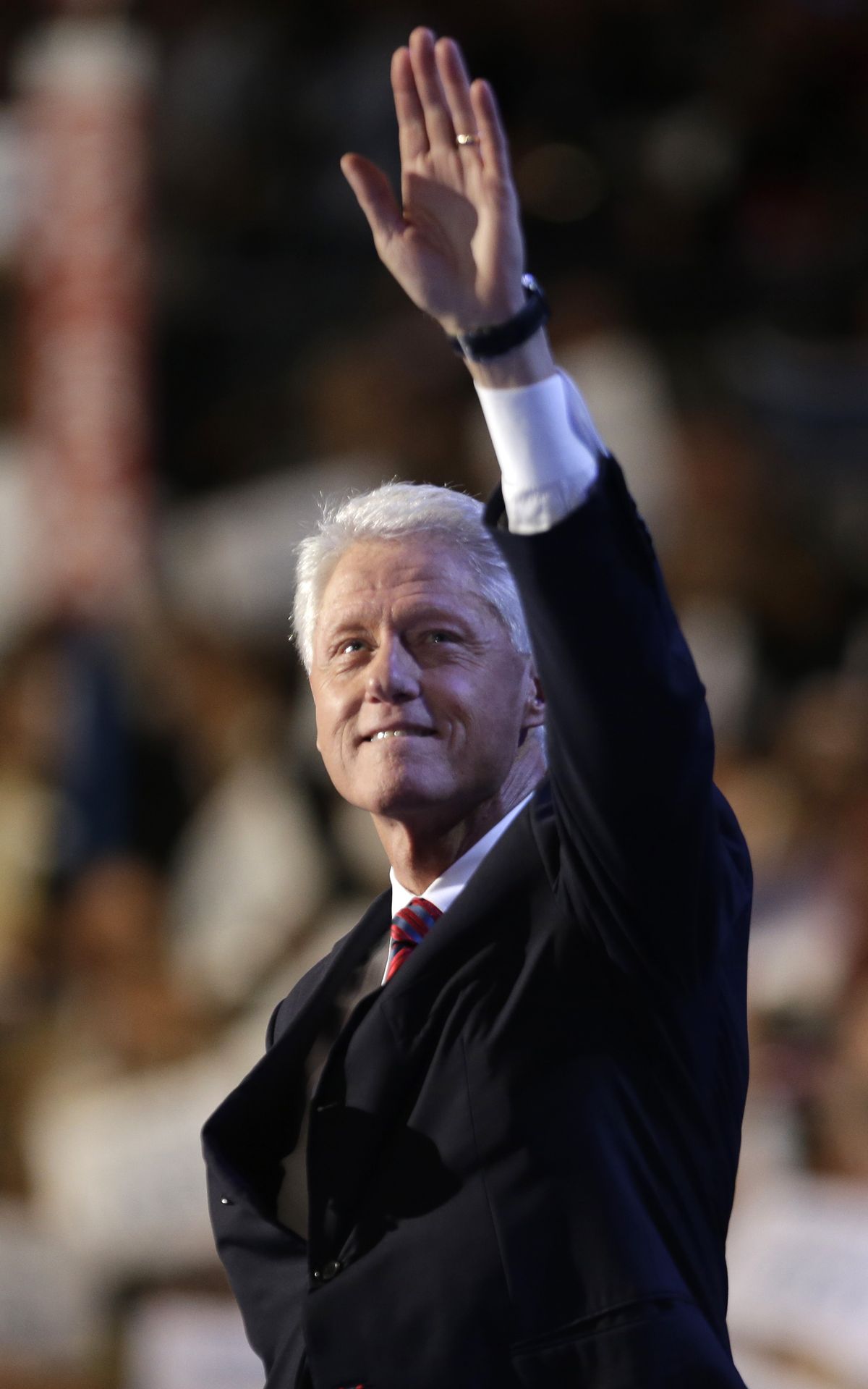Former President Bill Clinton acknowledges an adoring crowd as he addresses the convention Wednesday. (Associated Press)
